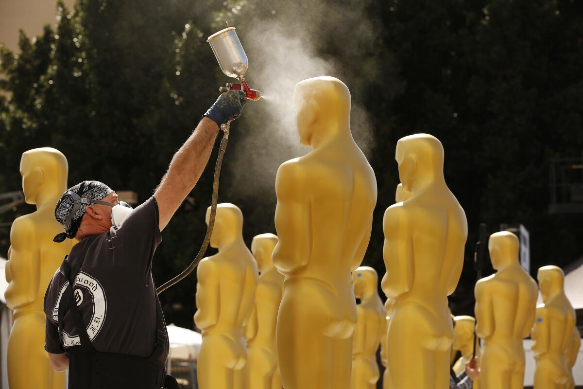 Rick Roberts is preparing Oscar statues with gold paint 