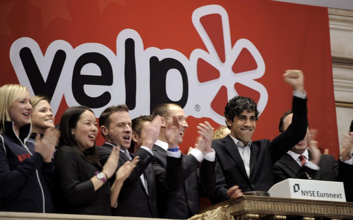 Yelp Chief Executive Jeremy Stoppelman celebrates while ringing the opening bell with employees during his company's initial public offering at the New York Stock Exchange in 2012.