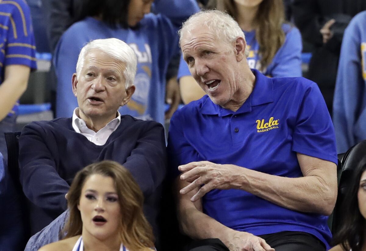 Former UCLA basketball player Bill Walton talks to UCLA Chancellor Gene Block during a game at Pauley Pavilion.