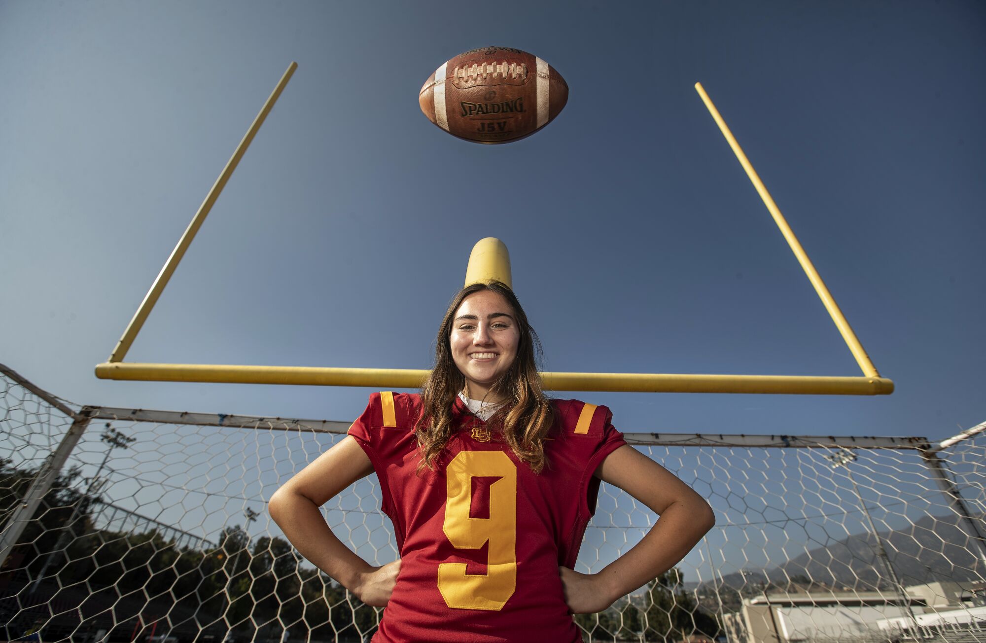 Shaina Clorfeine poses for a photo in the end zone of the La Canada practice field.