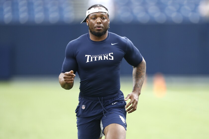 Tennessee Titans running back Derrick Henry warms up before a preseason NFL football game against the Chicago Bears, Saturday, Aug. 28, 2021, in Nashville, Tenn. Henry became the first to lead the NFL in rushing in back-to-back seasons since LaDainian Tomlinson in 2006-07, and also was the eighth man to run for at least 2,000 yards. Nobody in the NFL has carried the ball as much as Henry the past two seasons, and the Titans limited his work this preseason to keep him fresh as possible. (AP Photo/Wade Payne)