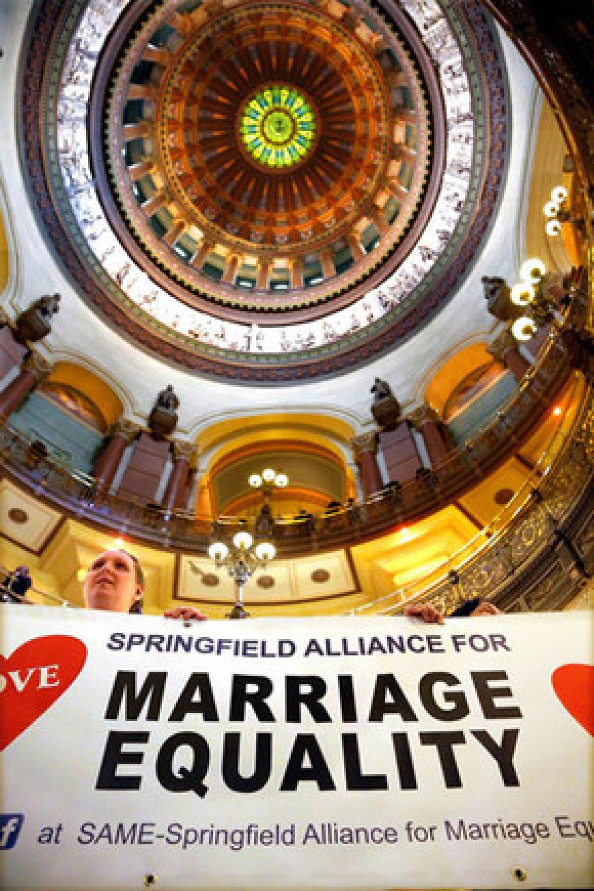 Supporters of same-sex marriage legislation rally in the rotunda at the Illinois state Capitol.