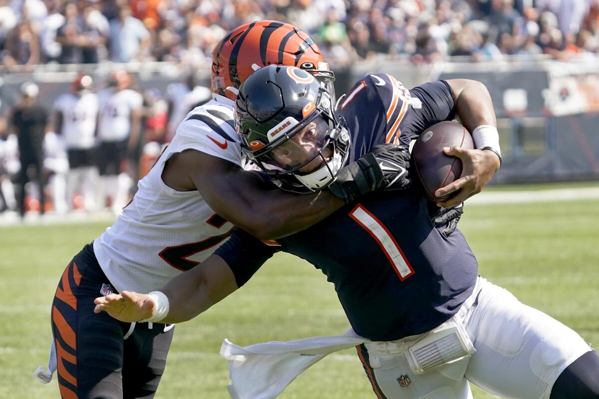 Chicago Bears quarterback Justin Fields is tackled by Cincinnati Bengals cornerback Chidobe Awuzie.