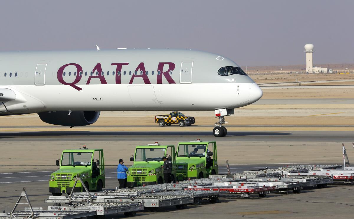 FILE - The first Qatar Airways plane in three years lands at King Khalid Airport in Riyadh, Saudi Arabia, Monday, Jan. 11, 2021. Qatar Airways, one of the Mideast's largest carriers known for on-board comfort and luxury, said Thursday, June 16, 2022 its profits over the past fiscal year topped $1.5 billion, marking the highest ever earnings for the state-owned carrier as it prepares to see a record surge in travelers for the upcoming FIFA World Cup soccer games. (AP Photo/Amr Nabil, File)