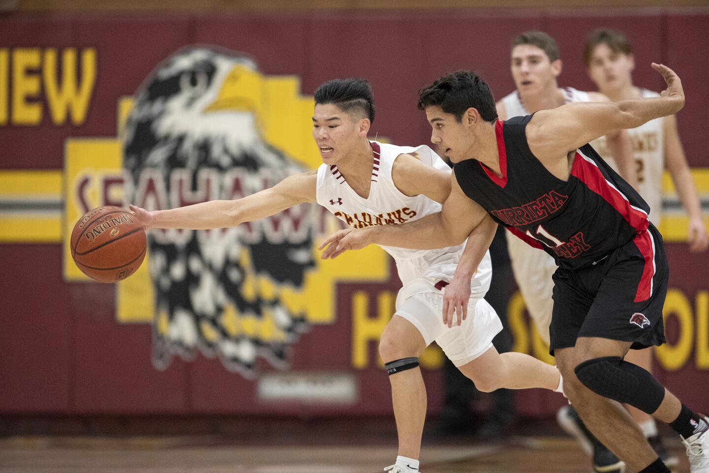 Ocean View High's Carson Nguyen, left, scrambles for a ball against Murrieta Valley's Anthony Montion in a first round of the CIF Southern Section Division 3AA playoffs at home Friday.