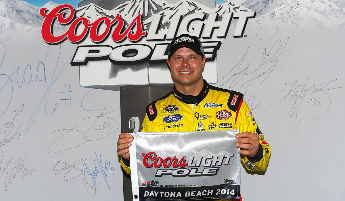 NASCAR driver David Gilliland celebrates Friday after winning the pole position in qualifying for the NASCAR Sprint Cup Series Coke Zero 400 at Daytona International Speedway.