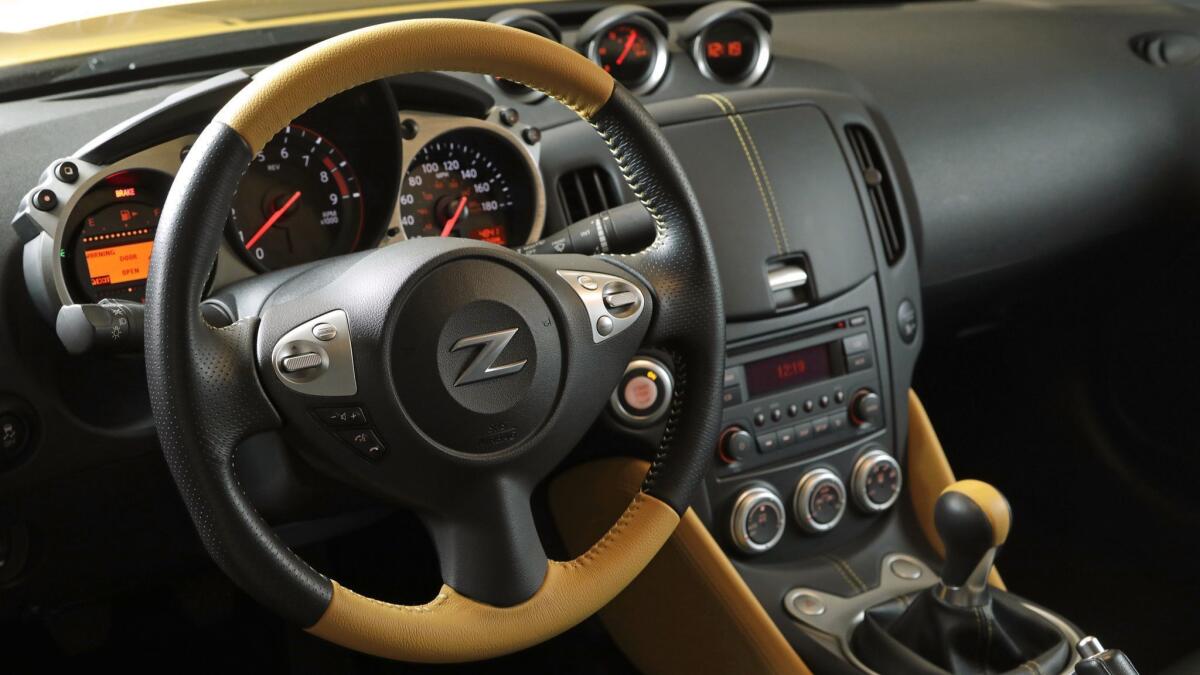 The Nissan 370 Heritage Edition features yellow accents throughout its interior — and a lidded cubby in the center console that has vexed drivers.