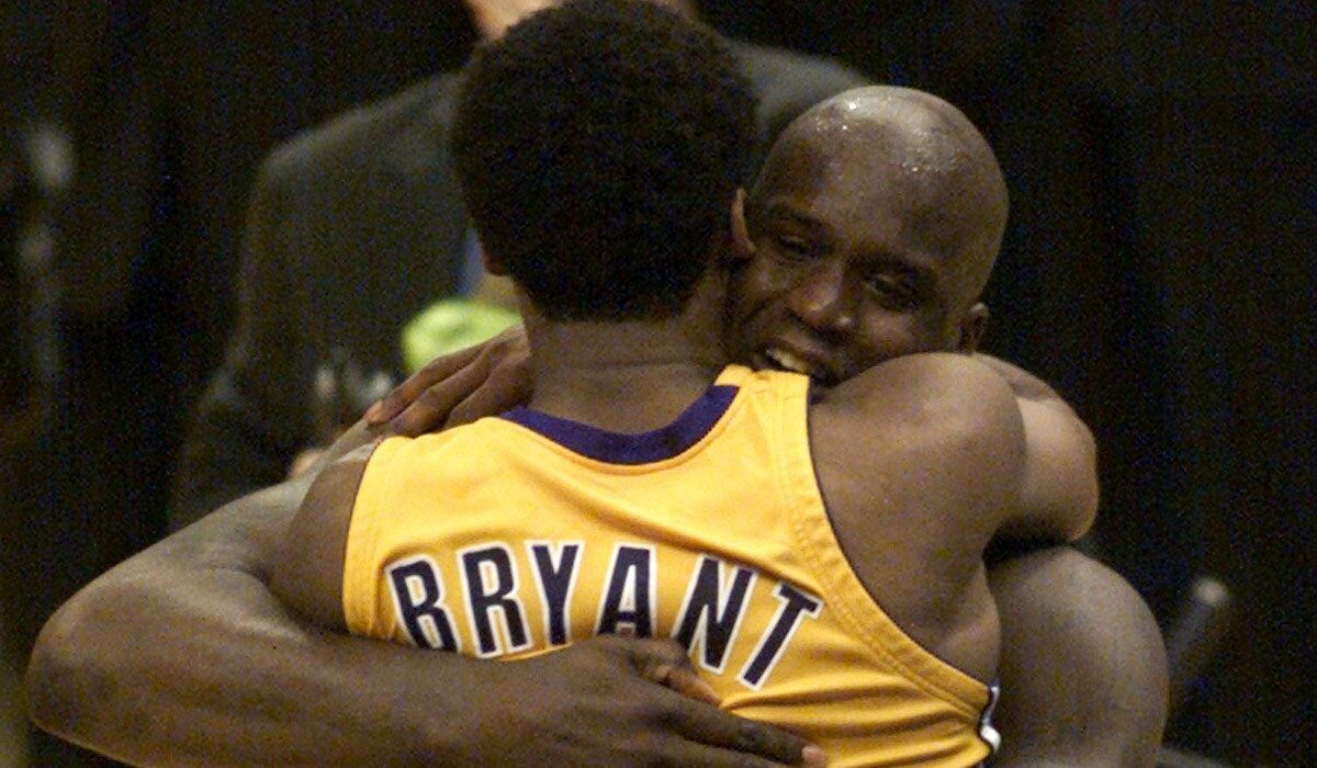 Kobe Bryant jumps into the arms of Shaquille O'Neal after the Lakers clinched the NBA title in 2000.