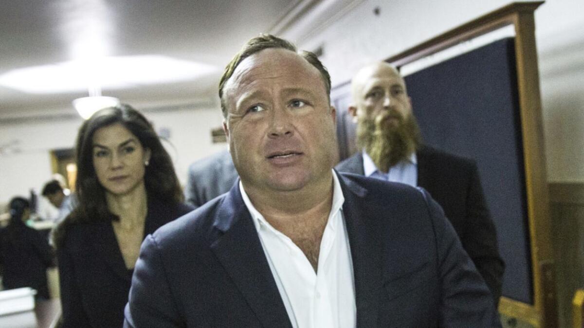 Alex Jones is accused of defaming the parents of children killed in the Newtown, Conn., school massacre by calling them “crisis actors” and insisting the shooting never happened.