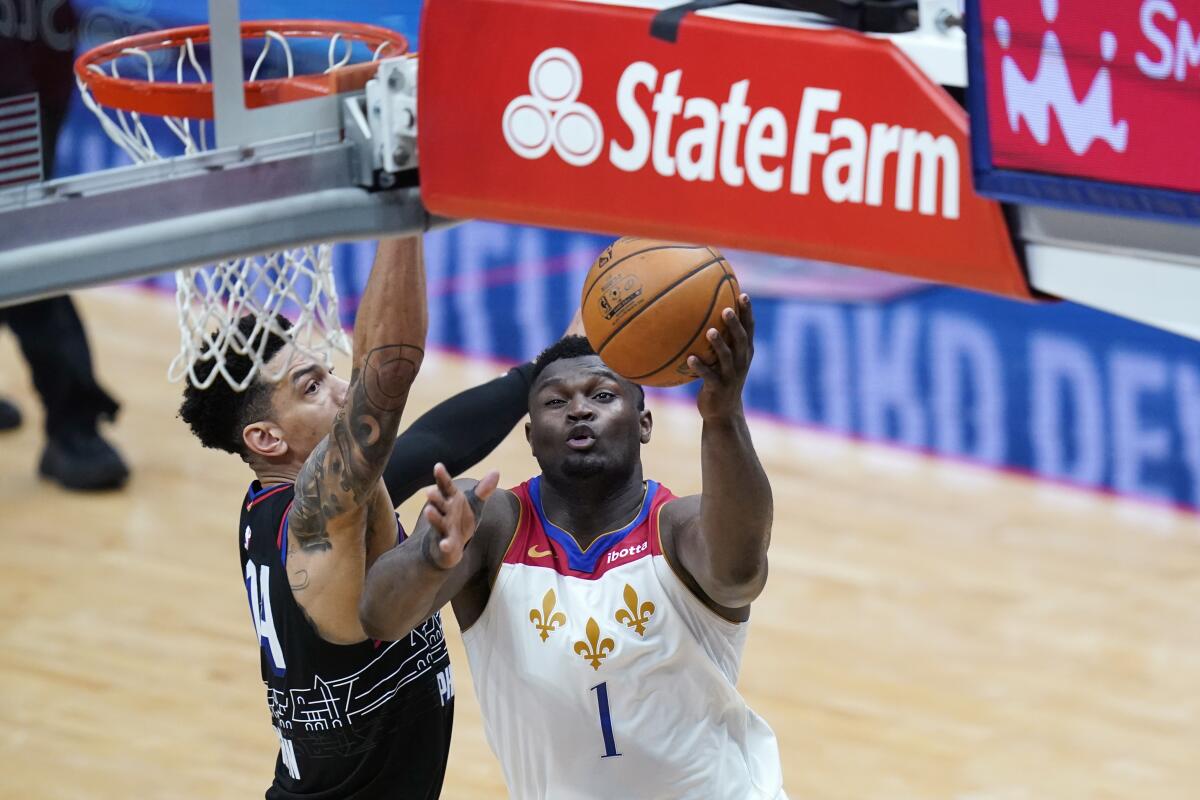 New Orleans Pelicans forward Zion Williamson (1) goes to the basket against Philadelphia 76ers forward Danny Green in the second half of an NBA basketball game in New Orleans, Friday, April 9, 2021. The Pelicans won 101-94. (AP Photo/Gerald Herbert)