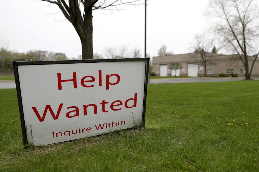 FILE - In this May 5, 2020 file photo, a help wanted sign shows at Illinois Air Team Test Station in Lincolnshire, Ill. U.S. employers advertised more jobs in June 2020 compared with May, but overall hiring fell, painting a mixed picture of the job market. The number of jobs posted on the last day in June jumped 9.6% to 5.9 million, the Labor Department said Monday, Aug. 10 a solid gain but still below the pre-pandemic level of about 7 million. (AP Photo/Nam Y. Huh)