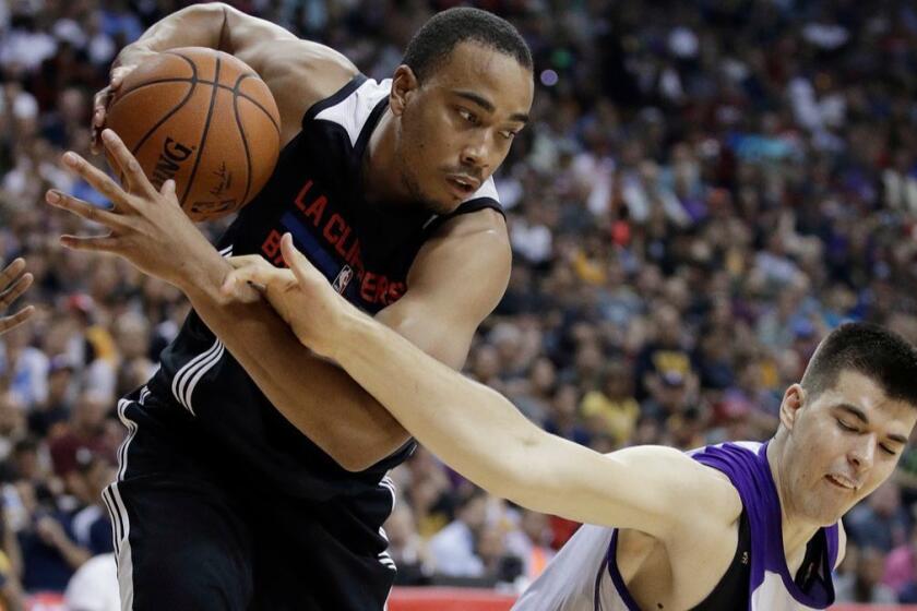 Los Angeles Clippers' Brice Johnson, left, pulls the ball away fom Los Angeles Lakers' Ivica Zubac during the second half of an NBA summer league basketball game, Friday, July 7, 2017, in Las Vegas. (AP Photo/John Locher)
