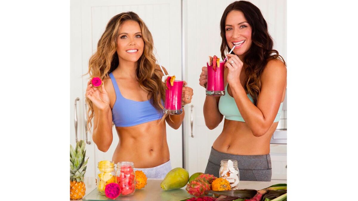 Katrina Scott, left, and Karena Dawn can be seen on @toneitup. (Tone It Up)