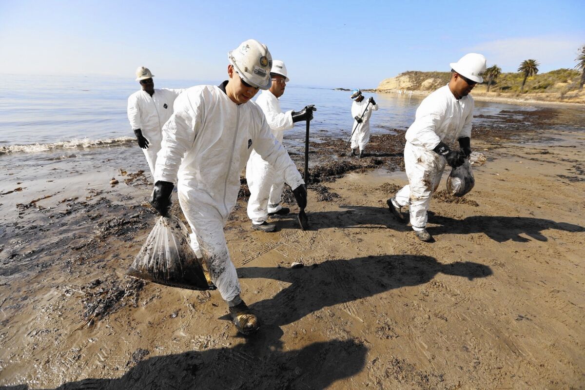 Cleanup crews bag oiled sand at Refugio State Beach in 2015.