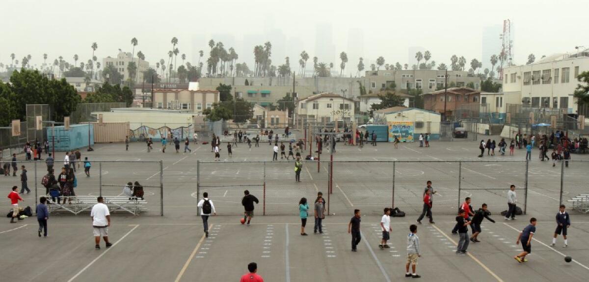 Kids play at an L.A. school. A new study looked at the long-term happiness of the "cool kids."