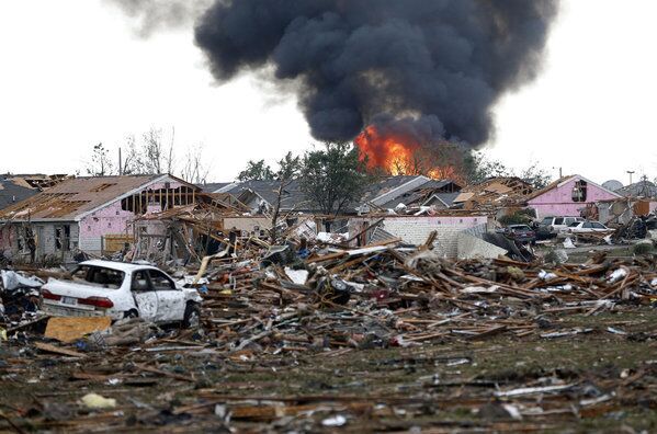 A fire burns in the Tower Plaza Addition in Moore, Okla., after a tornado roared through.