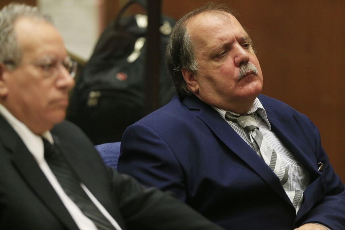 Former Bell City Councilman Victor Bello, right, represented by his attorney Leo Moriarty, listens to the proceedings in Los Angeles County Superior Court, where he was sentenced Friday.