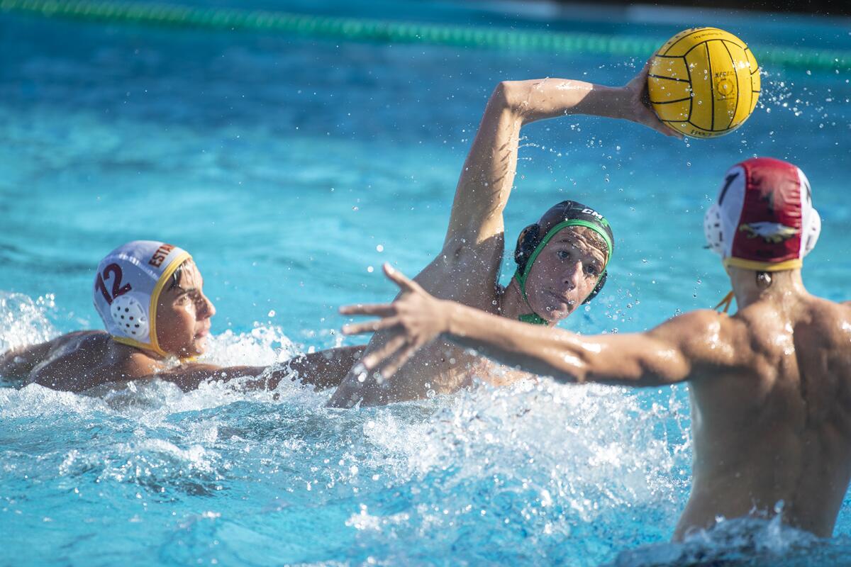 Costa Mesa's Will Harrington takes a shot and scores on Estancia goalkeeper Griffin Beth in an Orange Coast League match at home on Wednesday.