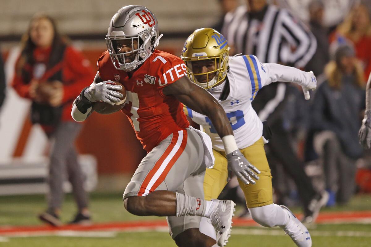 Utah running back Devonta'e Henry-Cole (7) outruns UCLA defensive back Elijah Gates.