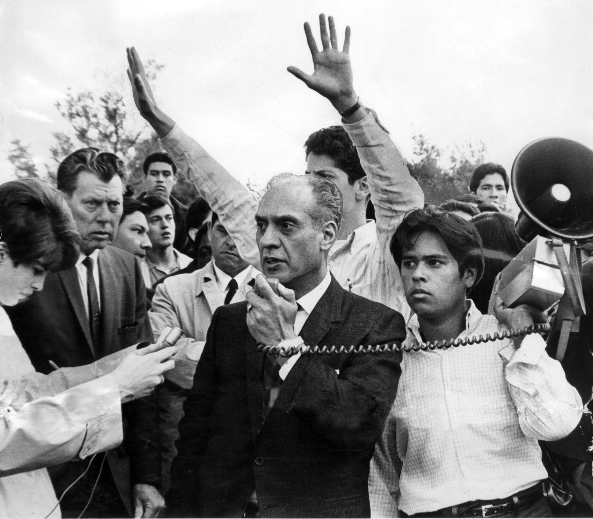 Rep. Edward Roybal speaks into a megaphone