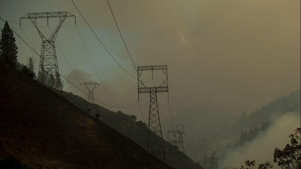 Power transmission lines crest a hilltop above Camp Creek Road, the point of origin of the Camp Fire, in Pulga, Calif. on Nov. 11.