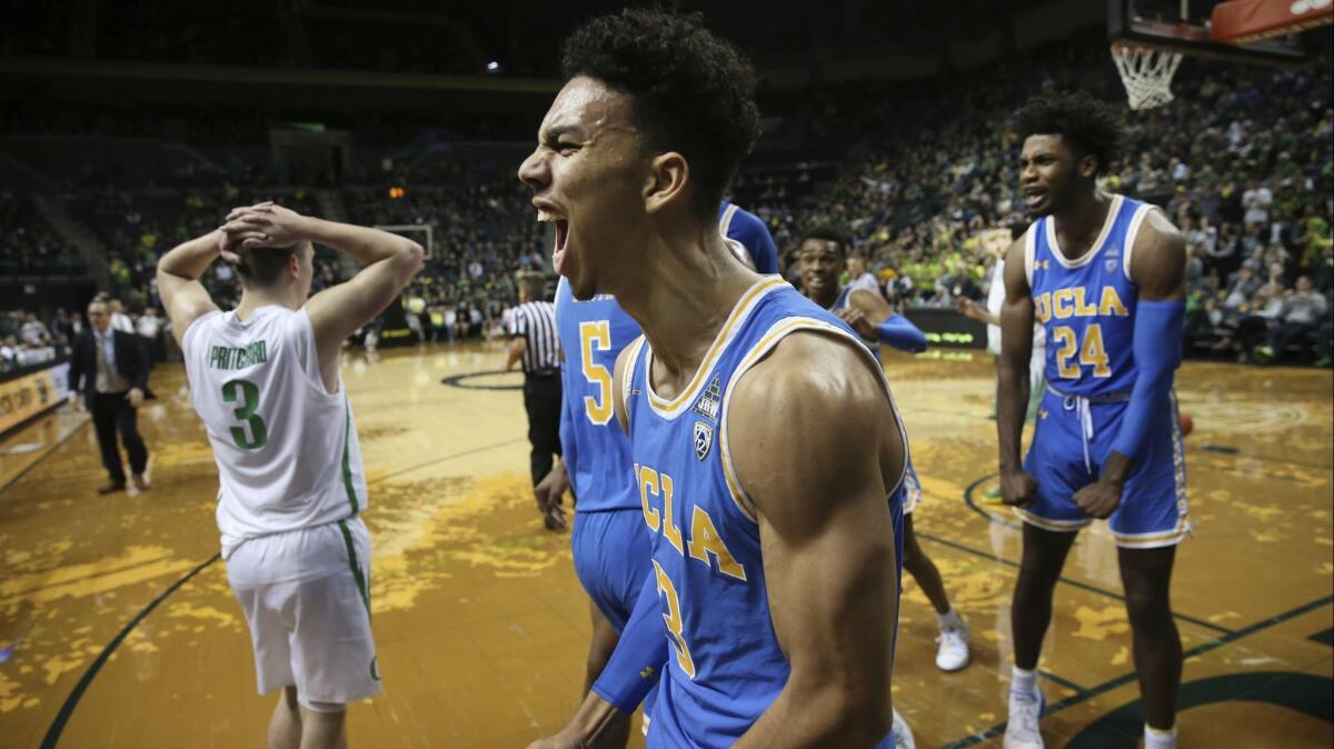 UCLA's Jules Bernard, center, and Jalen Hill, react as the Bruins close the gap against Payton Pritchard, left, and Oregon on Thursday night.