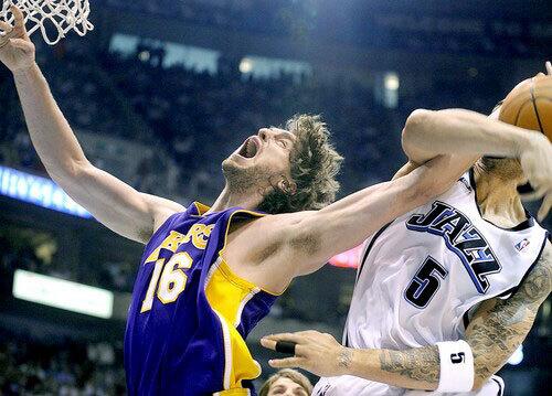 Lakers forward Pau Gasol, who started at center, has his shot blocked by Jazz forward Carlos Boozer in the first half Saturday.