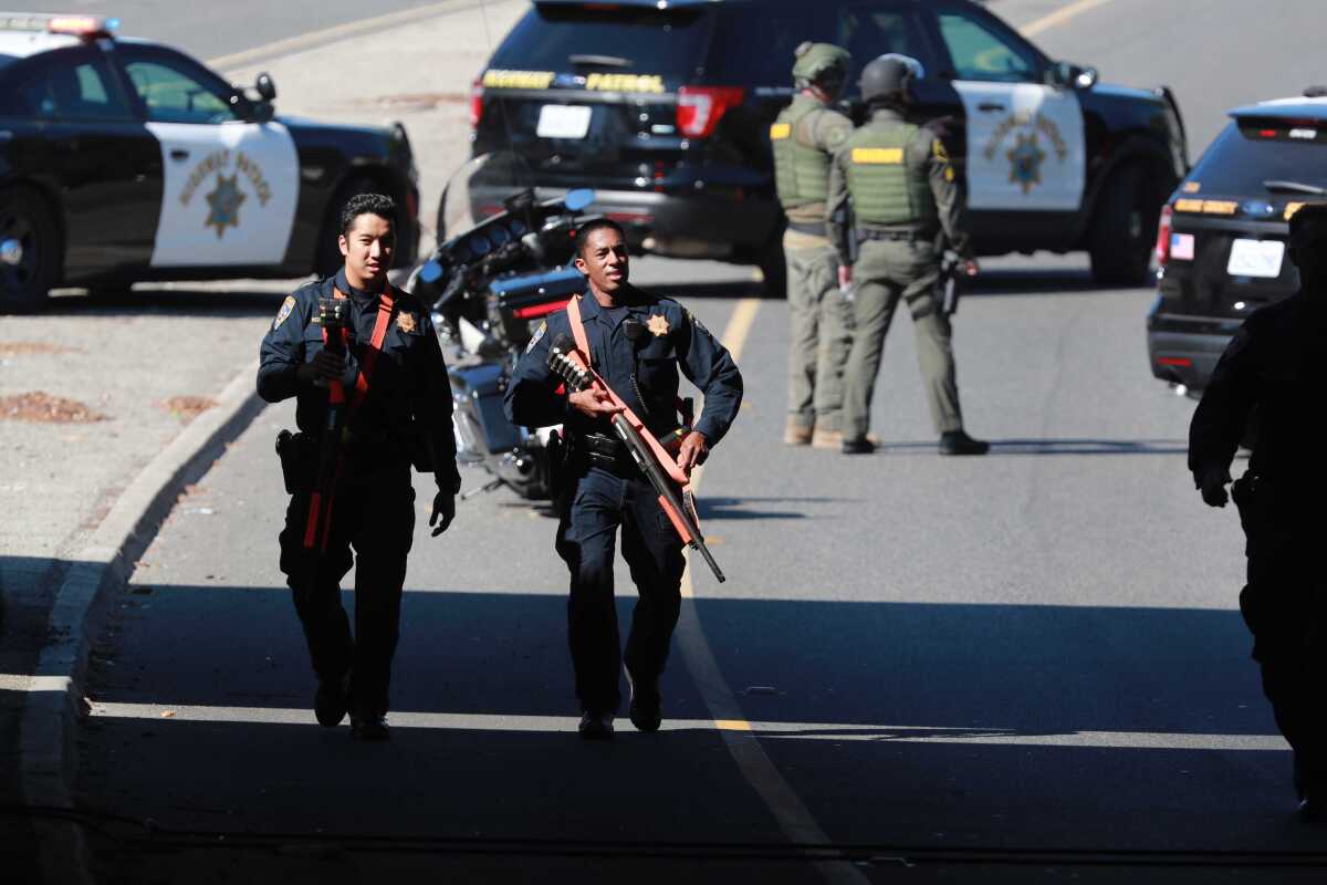 California Highway Patrol officers can be seen near the Katella Avenue onramp to the 605 Freeway in Los Alamitos Thursday.