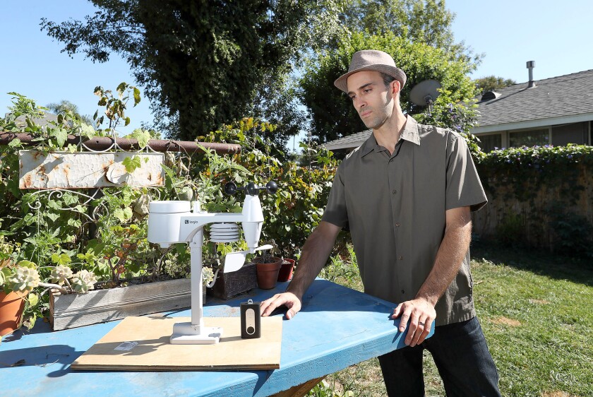 Dr. Shahir Masri, an air pollution scientist with UC Irvine, stands with a few of his devices that monitor air quality. 