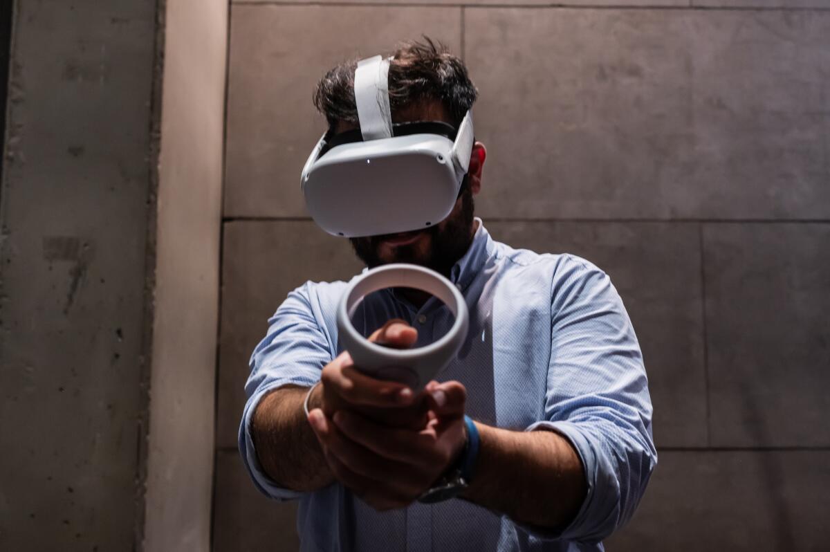 A man wearing a Meta Quest 2 all-in-one VR headset 