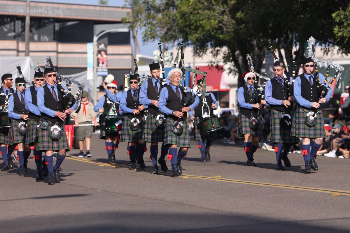 Bagpipers play holiday tunes during the La Jolla Christmas Parade in 2021.