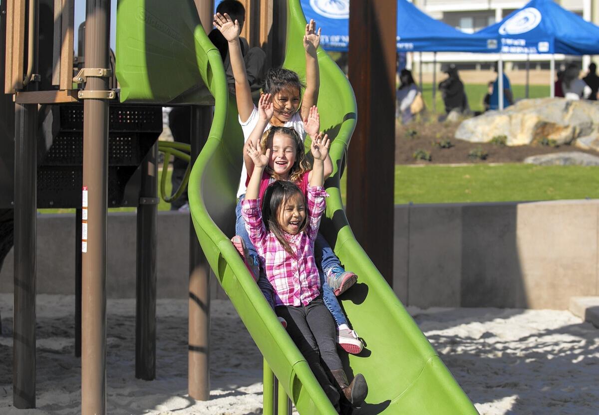 Children play at Sunset Ridge Park in Newport Beach, where the city proposes to build a public access road and 92-space parking lot.