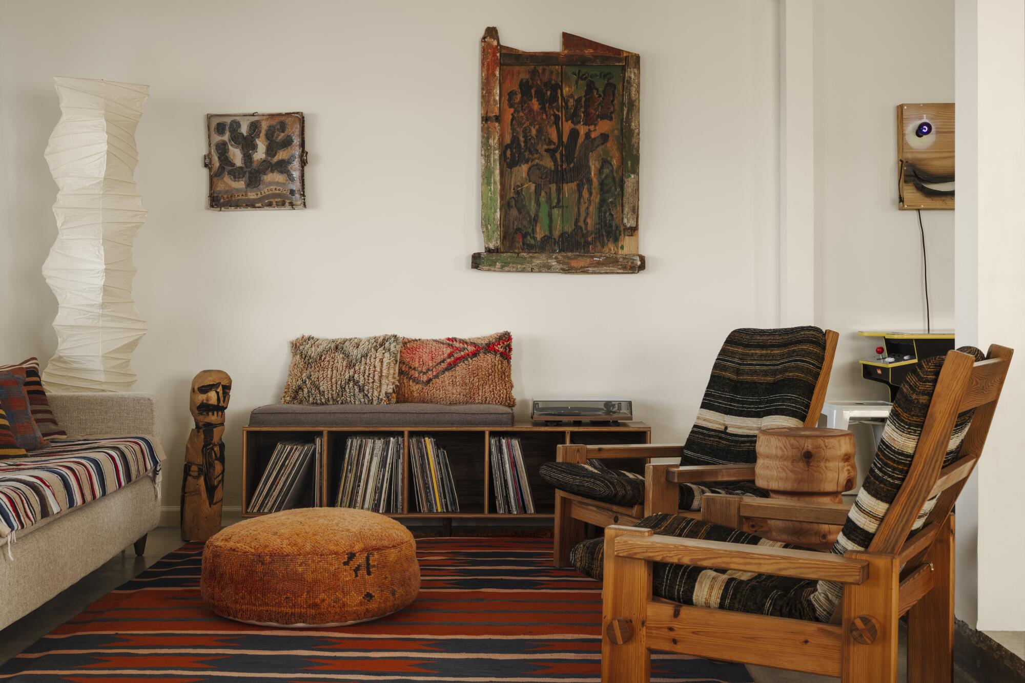 A living room with wooden furniture, records and art. 