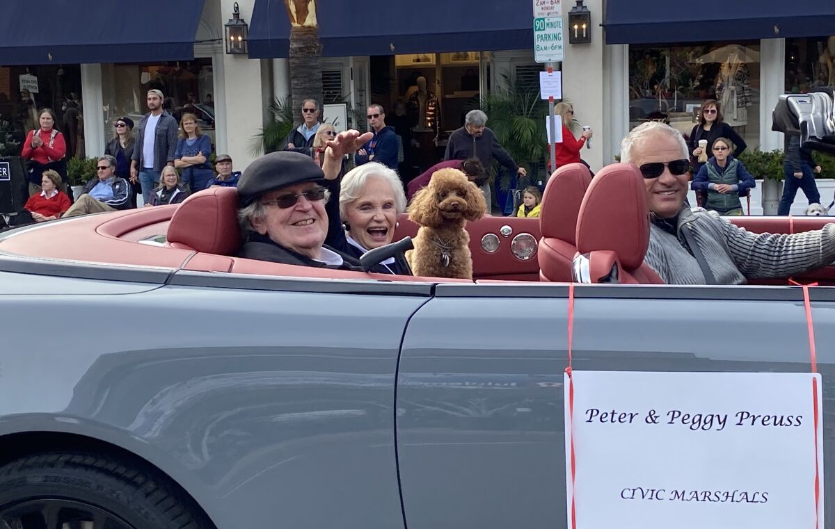 Civic marshals Peter and Peggy Preuss, founders of the Preuss School, ride in a Rolls-Royce Dawn.