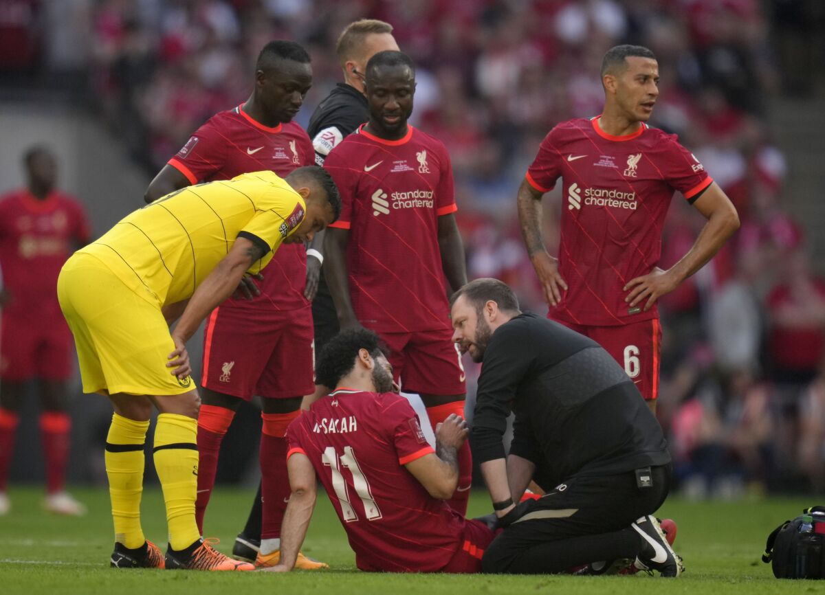 Liverpool's Mohamed Salah receives medical treatment during the English FA Cup final soccer match between Chelsea and Liverpool, at Wembley stadium, in London, Saturday, May 14, 2022. (AP Photo/Kirsty Wigglesworth)