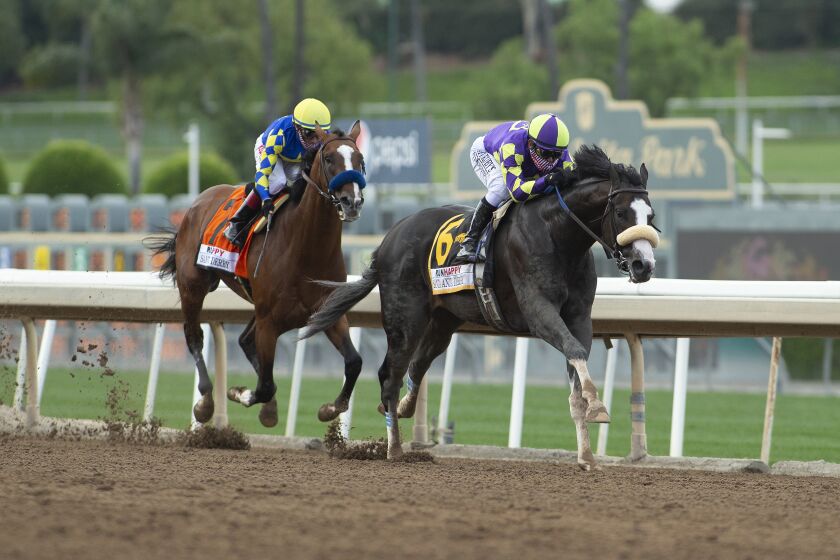 In a photo provided by Benoit Photo,C R K Stable's Honor A.P. and jockey Mike Smith, right, glide by Authentic and jockey Drayden Van Dyke in mid-stretch and to on to win the Grade I $400,000 RUNHAPPY Santa Anita Derby Saturday, June 6, 2020 at Santa Anita Park in Arcadia, Calif. (Benoit Photo via AP)