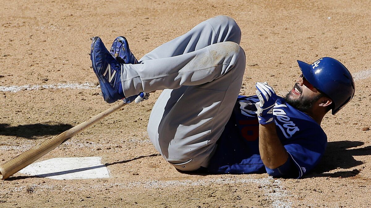 Los Angeles Dodgers' Andre Ethier rolls on the ground during a spring training baseball game against the Arizona Diamondbacks in Scottsdale, Ariz., on March 18, 2016.