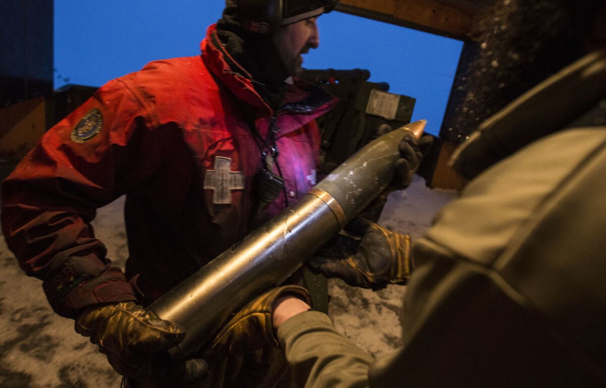 Mammoth Mountain ski patrolman Cliff Klock prepares to load a 105mm shell into the breach of a 1943 howitzer to mitigate avalanche paths in Mammoth Lakes.