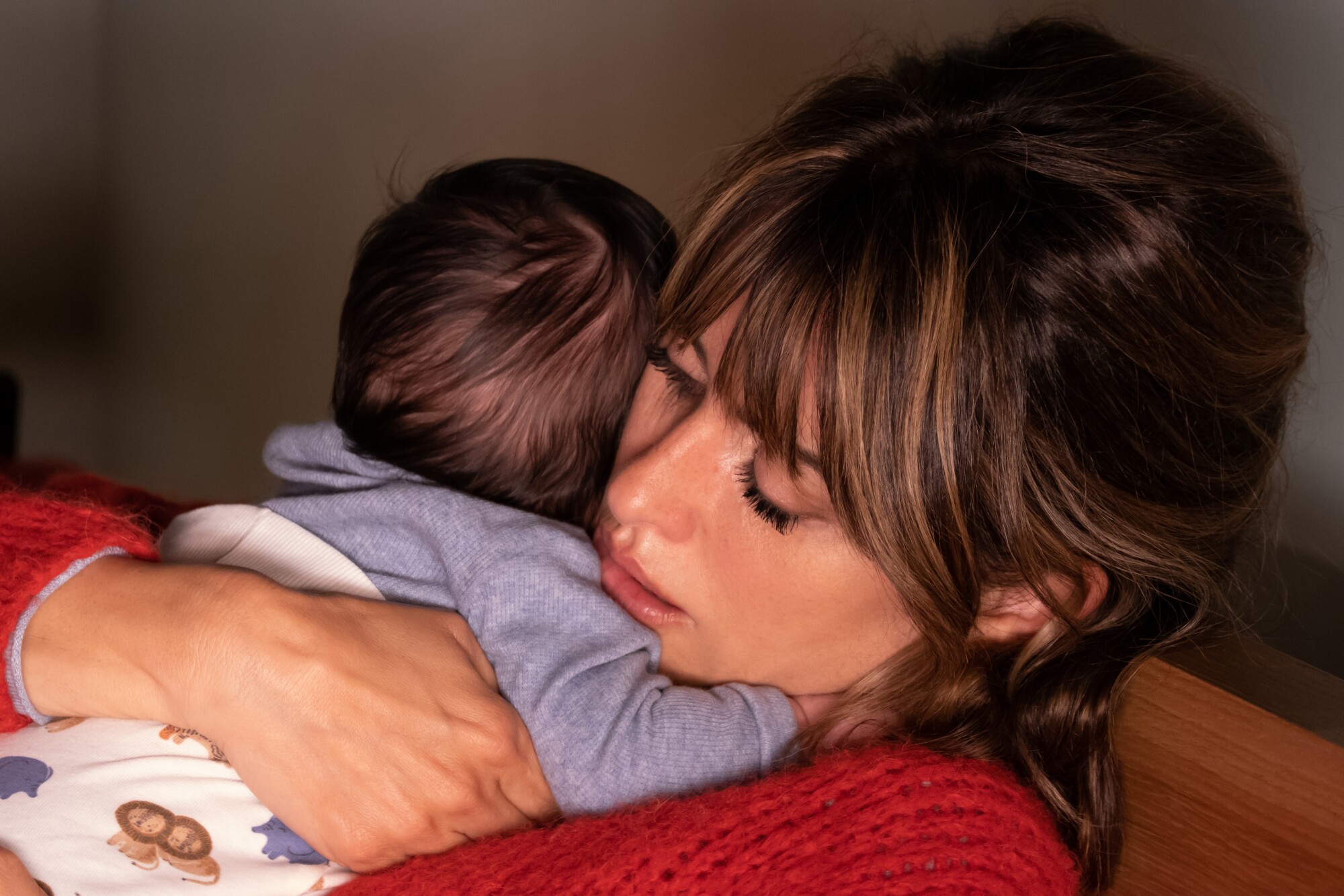 Penélope Cruz holds a baby in “Parallel Mothers.”
