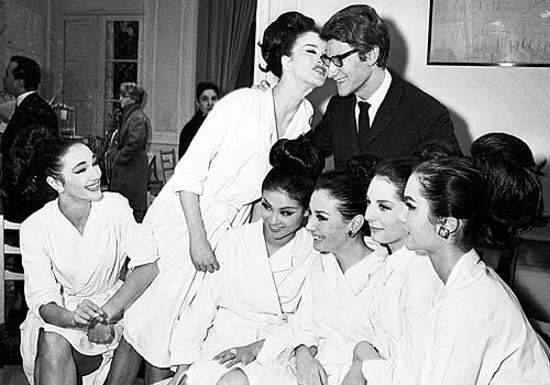 Saint Laurent poses with models after the presentation of his spring collection in Paris in February 1964. His dismissal from Dior had helped him launch his own company.