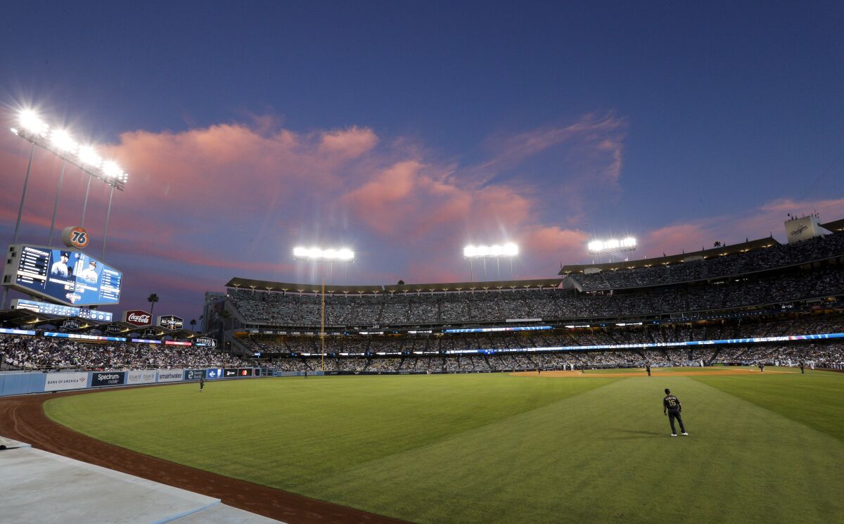 The clouds glow as the sun sets at Dodger Stadium during the All-Star Game on Tuesday.