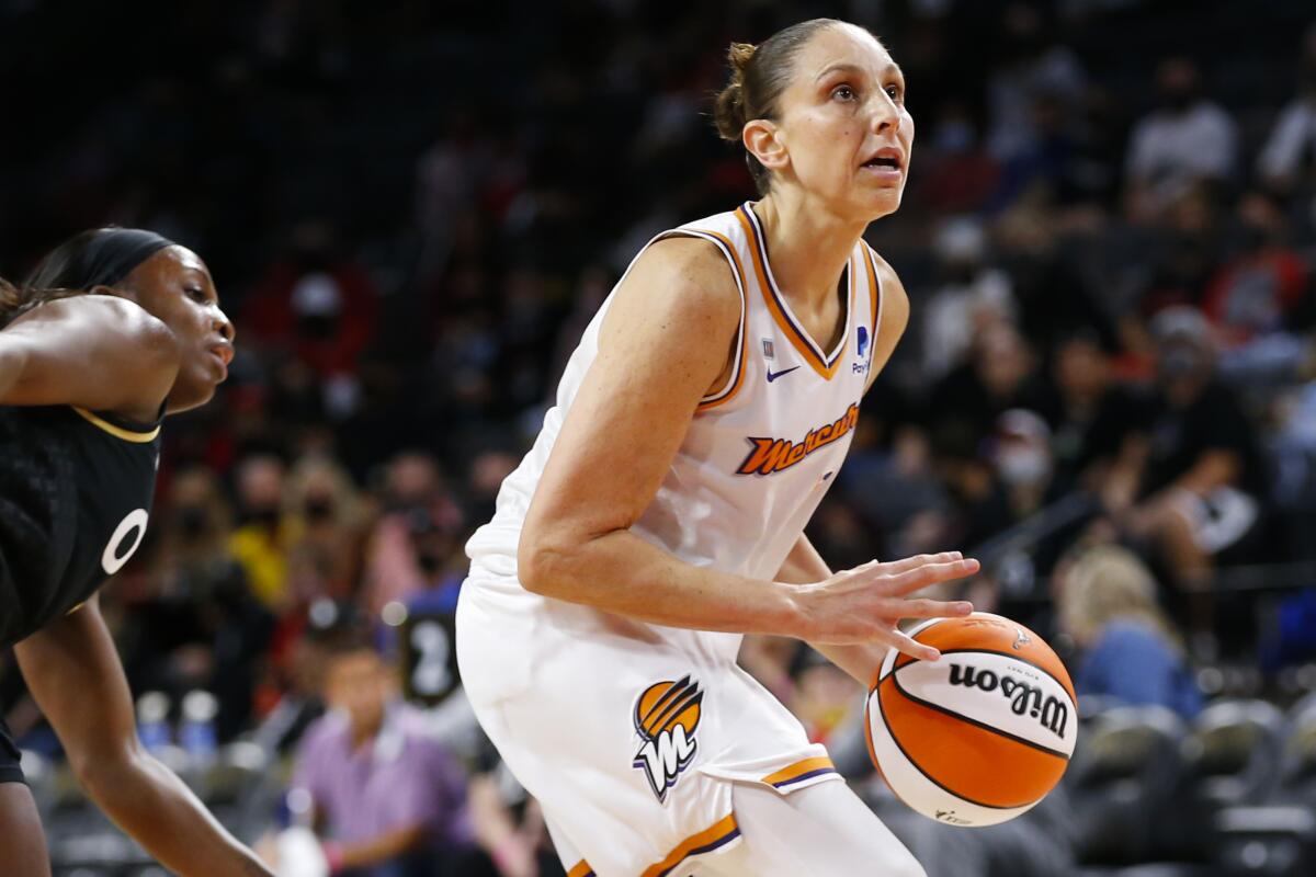 Phoenix Mercury guard Diana Taurasi (3) looks to shoot in front of Las Vegas Aces guard Jackie Young during the first half of Game 5 of a WNBA basketball playoff series Friday, Oct. 8, 2021, in Las Vegas. (AP Photo/Chase Stevens)
