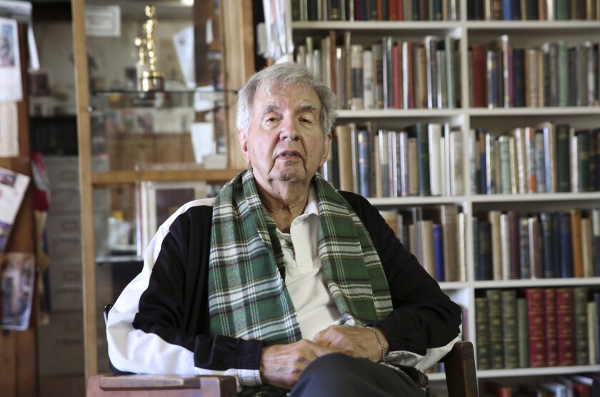 Larry McMurtry with a scarf around his neck at his Texas book shop