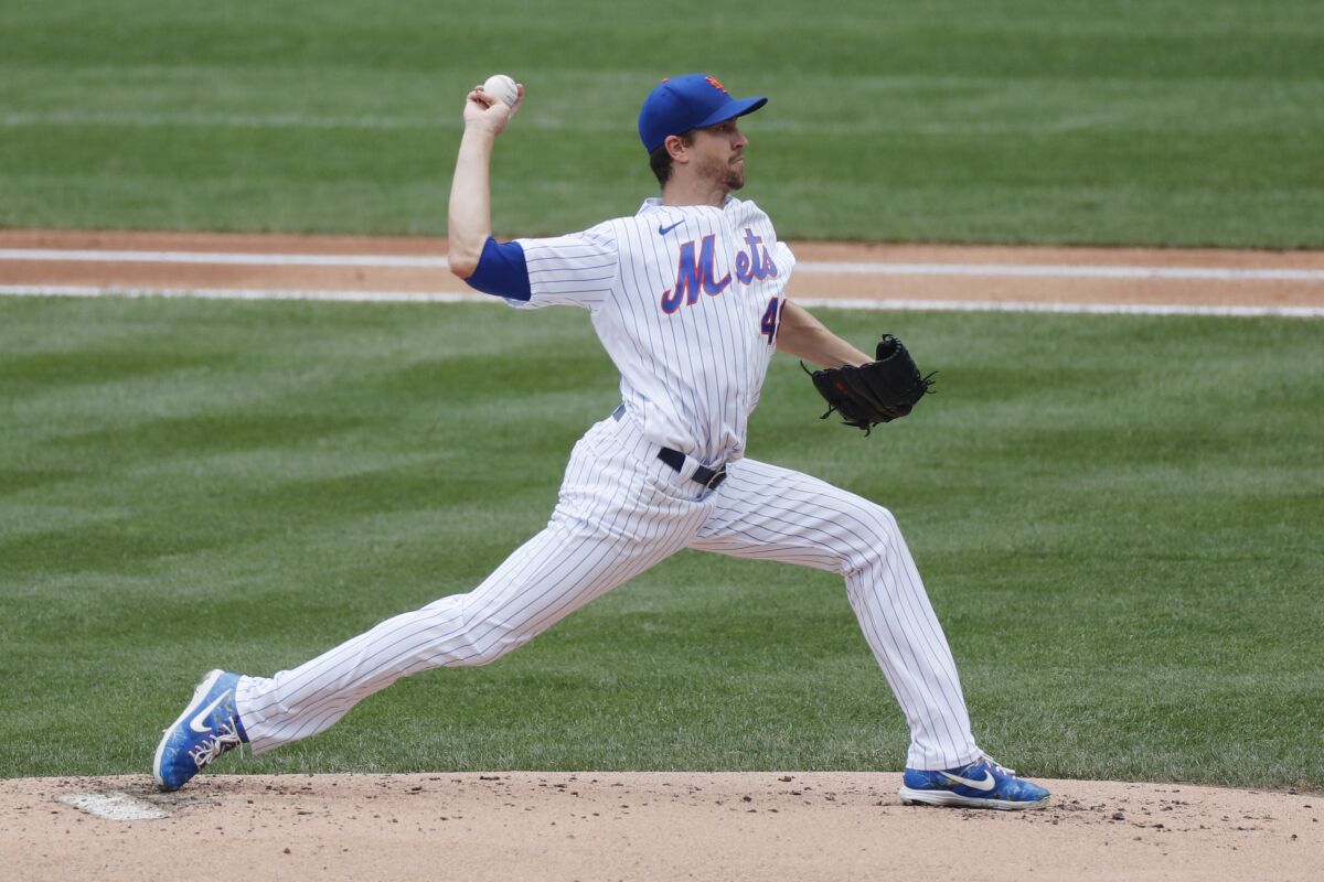 New York Mets starting pitcher Jacob deGrom winds up during the first inning of a baseball game against the Miami Marlins at Citi Field, Sunday, Aug. 9, 2020, in New York. (AP Photo/Kathy Willens)