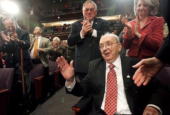 Former Sen. Jesse Helms acknowledges the crowd after being after being saluted by President Bush during an event in Raleigh, N.C.
