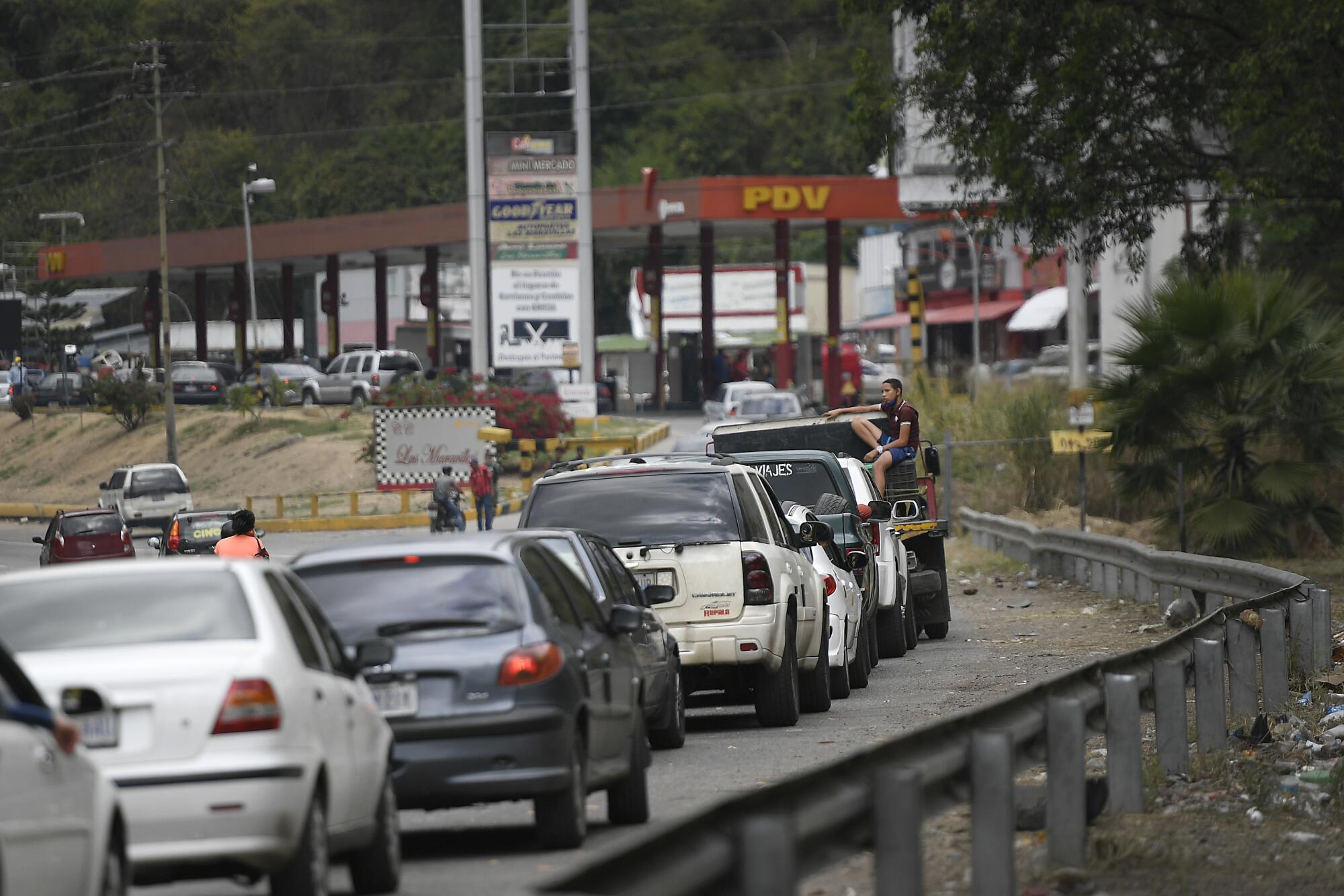 Vehicles wait in line to fill up at a gas station in Caracas, Venezuela.  