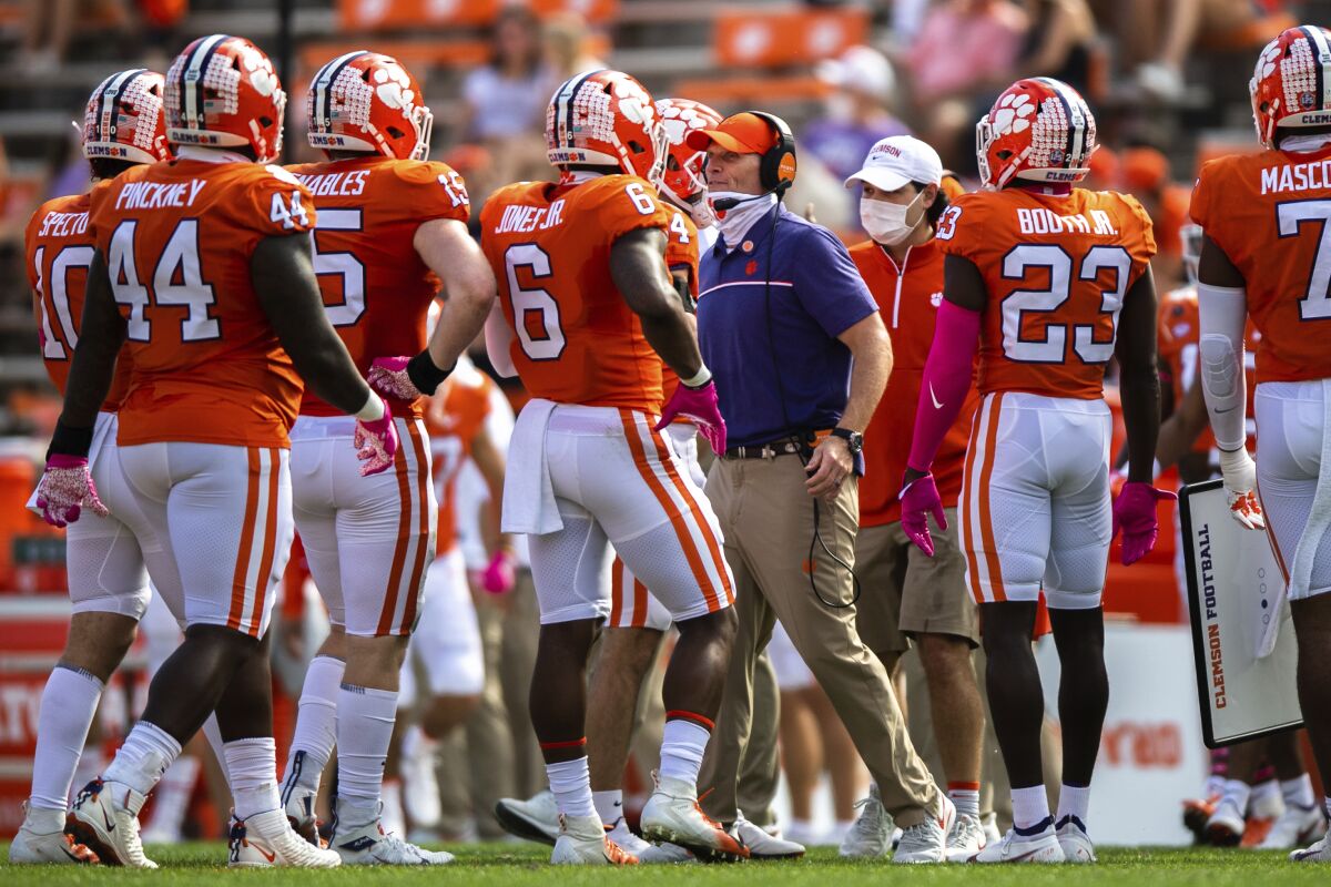 Clemson defensive coordinator Brent Venables, center right, talks to his players during an NCAA college football game against Syracuse in Clemson, S.C., Saturday, Oct. 24, 2020. (Ken Ruinard/Pool Photo via AP)
