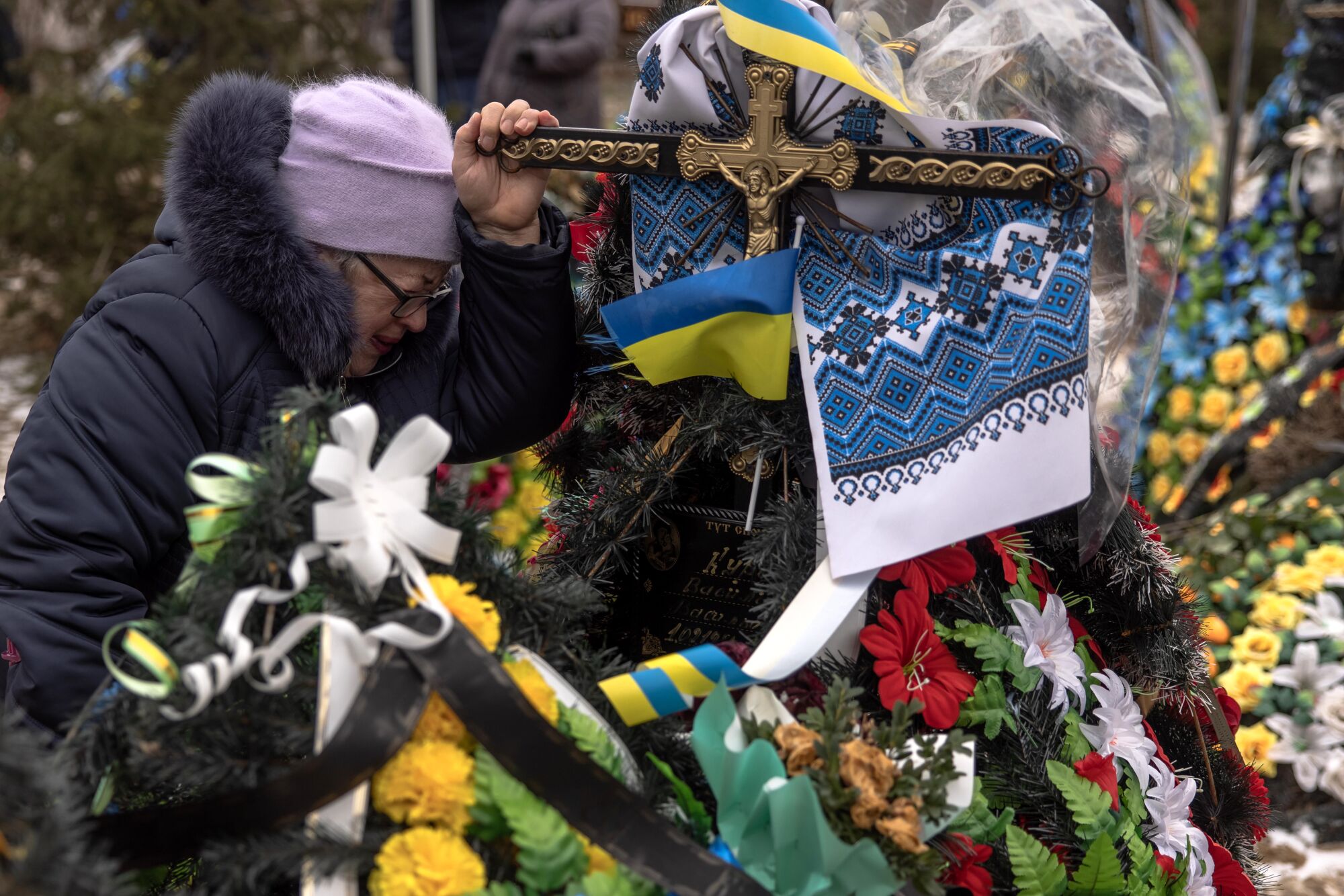 The mother of a Ukrainian soldier killed in Bakhmut grieves at his grave