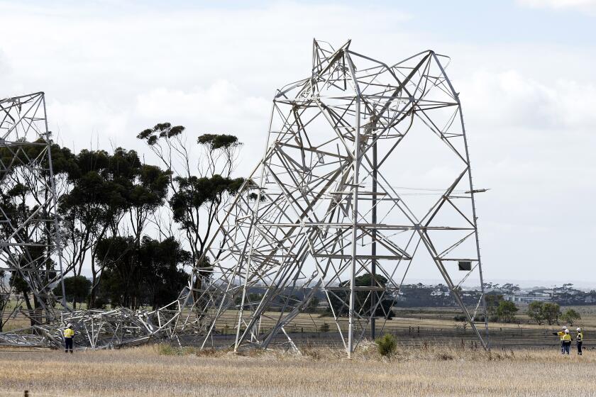 Trabajadores inspeccionan torres de transmisión eléctrica dañadas por el mal tiempo a las afueras de Melbourne, Australia, el 14 de febrero de 2024. (Con Chronis/AAP Image vía AP)