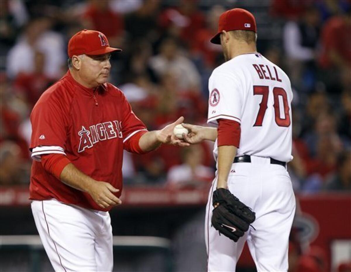 Los Angeles Angels manager Mike Scioscia, left, removes starting pitcher Trevor Bell from the baseball game in the sixth inning against the Cleveland Indians on Tuesday, Sept. 7, 2010, in Anaheim, Calif. (AP Photo/Alex Gallardo)